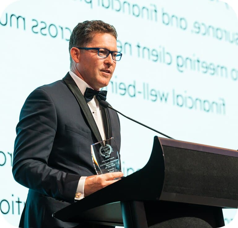 Warren Strybosch accepting an industry award on stage